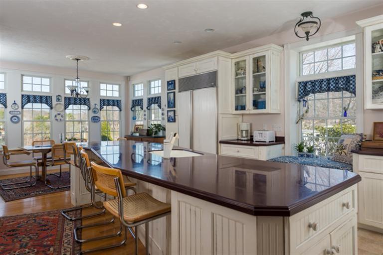 113 James Circle Mashpee, MA 02649 - Photo 8 of 21 a kitchen with sink refrigerator and large window