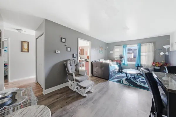 a living room with furniture rug and wooden floor