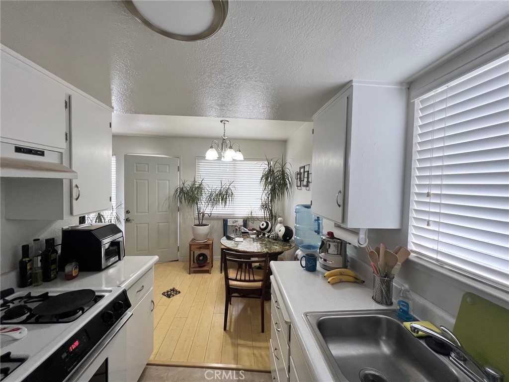 375 Surf Street Morro Bay, CA 93442 - Photo 13 of 25 a kitchen with a sink stove and cabinets