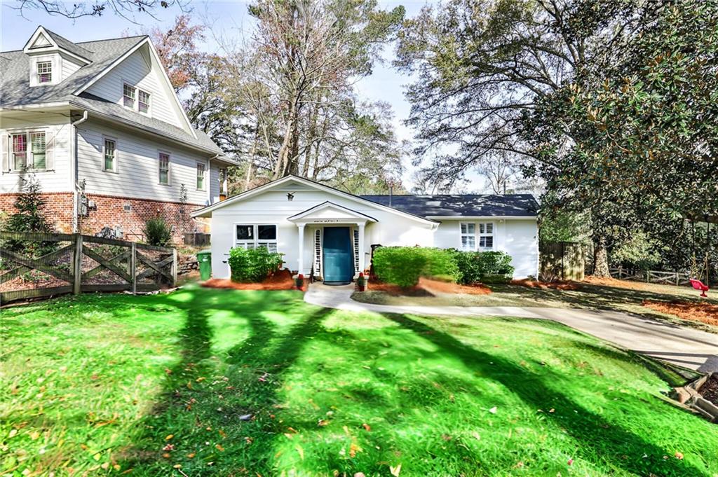1755 Warren Court Northwest Atlanta, GA 30318 - Photo 1 of 1 a front view of a house with yard and green space
