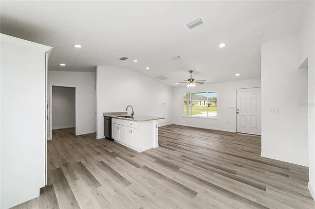 a view of kitchen with sink and wooden floor