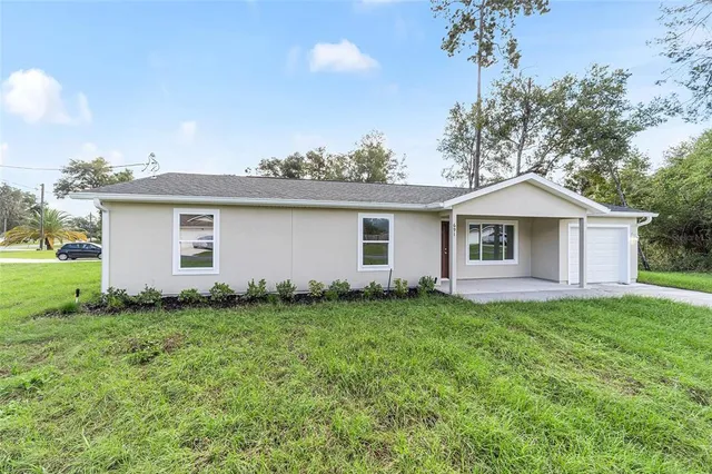 a front view of house with yard and green space