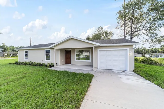 a front view of house with yard and green space