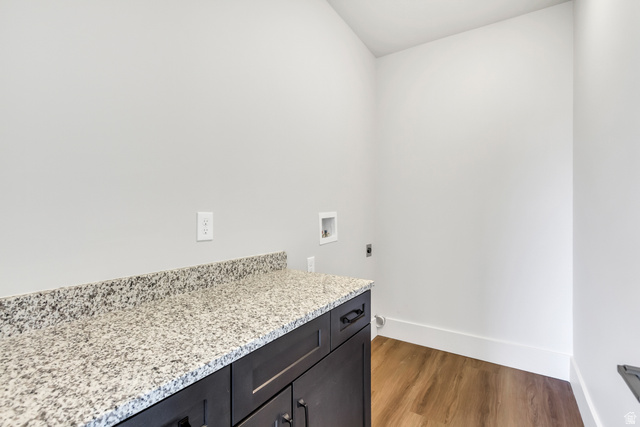 547 North Hvn Drive Mapleton, UT 84664 - Photo 20 of 23 Laundry area featuring light wood-style flooring, electric dryer hookup, washer hookup, and cabinet space