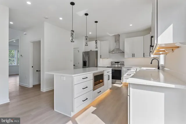 a kitchen with a sink stove and cabinets