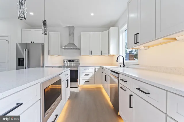 a kitchen with stainless steel appliances a sink and a stove