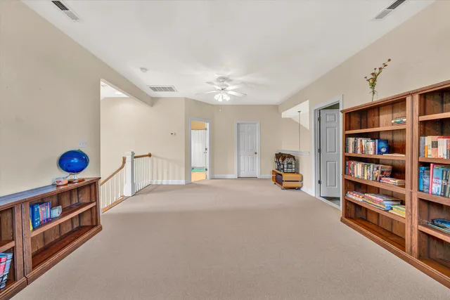 a living room with furniture and floor to ceiling windows