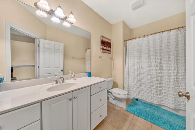 a dining room with furniture a chandelier and wooden floor
