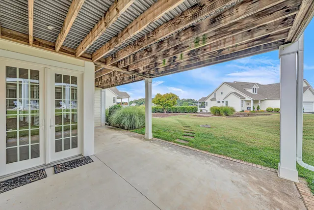 an aerial view of residential houses with outdoor space and parking