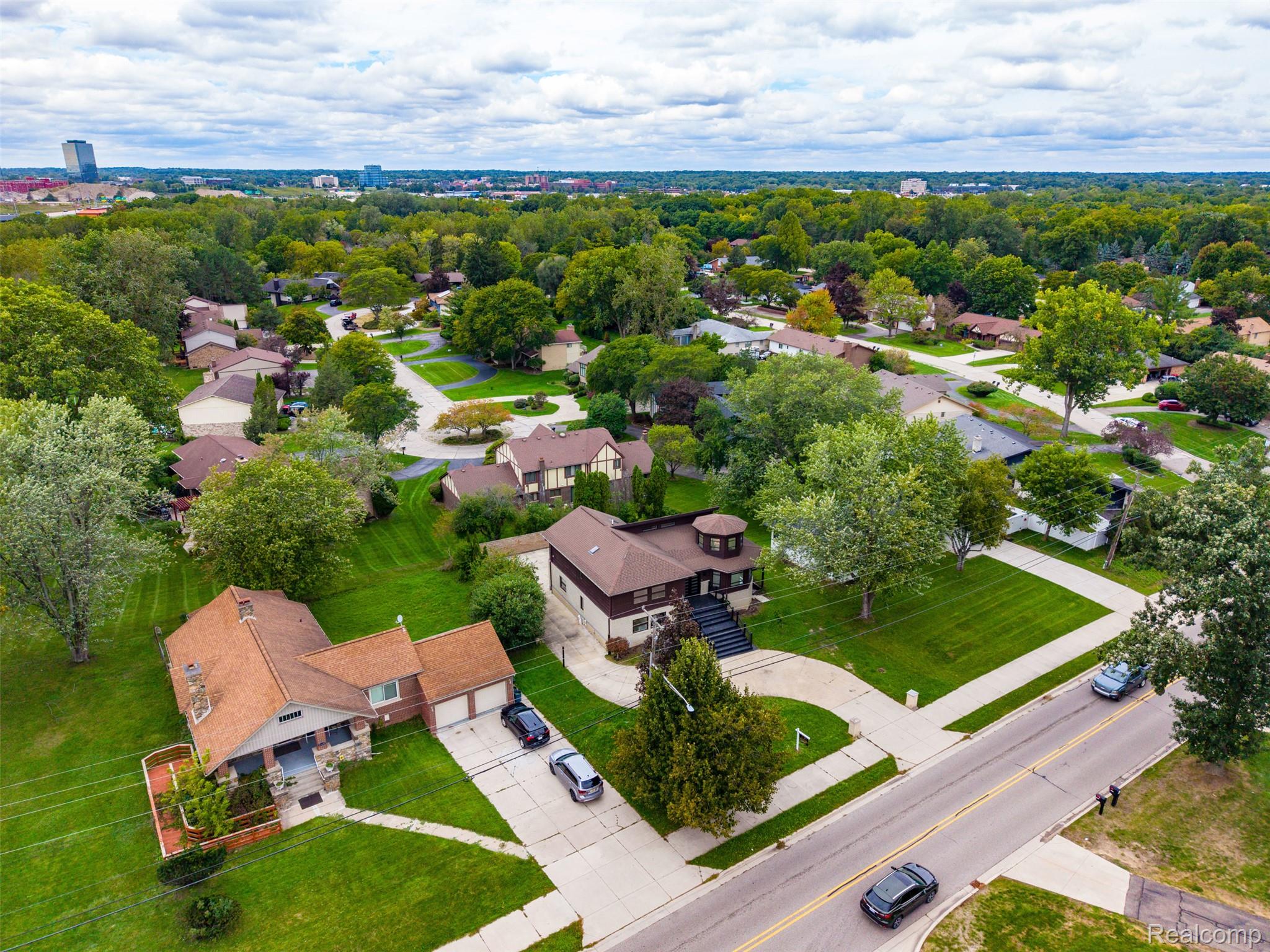 27507 Bell Road Southfield, MI 48034 - Photo 63 of 81 Residential property featuring brick and siding exterior, a multi-car driveway, and mature landscaping