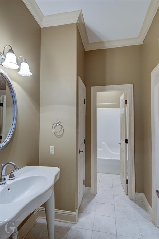1212 WPA Road Homer, LA 71040 - Photo 28 of 35 Bathroom with ornamental molding, tile patterned floors, baseboards, and a tub