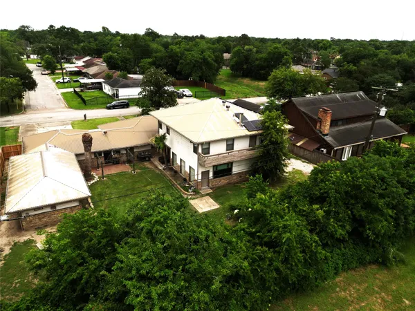 an aerial view of multiple houses with a yard
