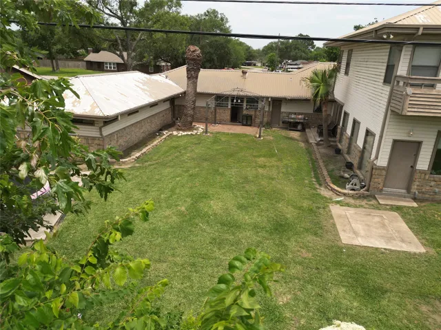 an aerial view of a house with swimming pool and patio