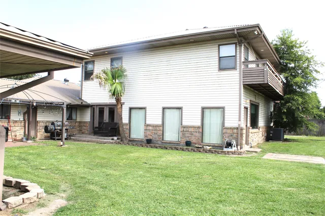 a front view of house with yard and outdoor seating