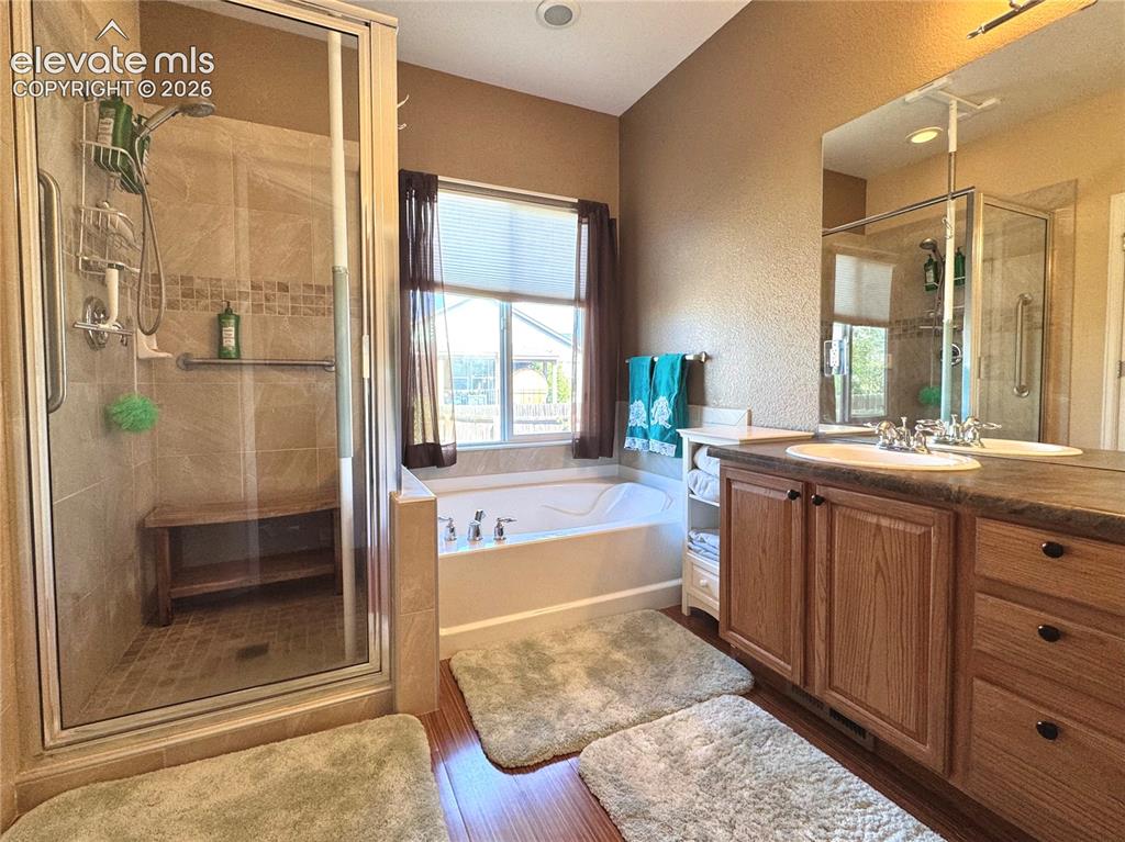 9362 St.George Road Peyton, CO 80831 - Photo 17 of 32 a bathroom with a tub sink and mirror