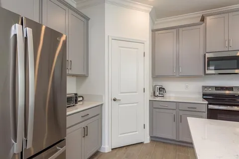 a bathroom with a shower sink and mirror