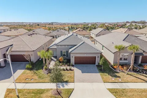 a view of a dining room with furniture wooden floor and chandelier