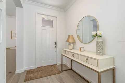 a living room with furniture a flat screen tv and a large window