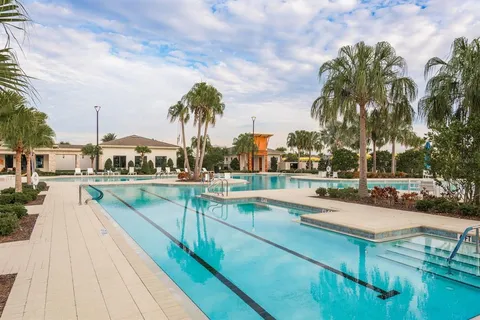 a view of a water with table and chairs