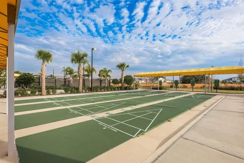 a view of a backyard with a patio and fire pit
