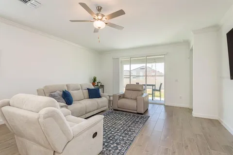 a living room with furniture and view of kitchen