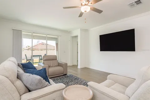 a living room with furniture and kitchen view