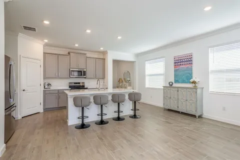 a kitchen with stainless steel appliances granite countertop a sink stove and refrigerator