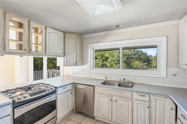 a kitchen with stainless steel appliances cabinets and a window