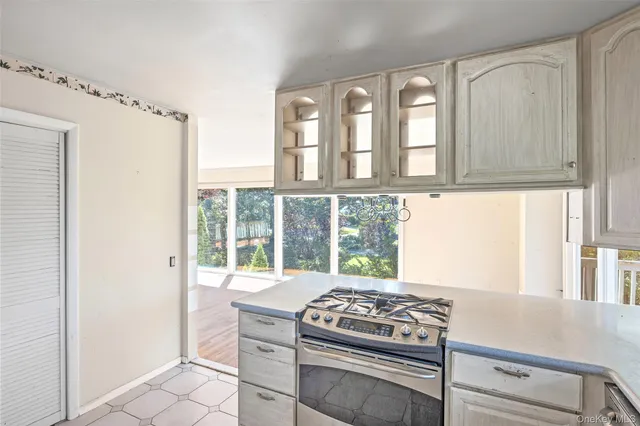 a kitchen with windows and a stove