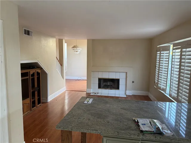 a view of an empty room with a fireplace and a window
