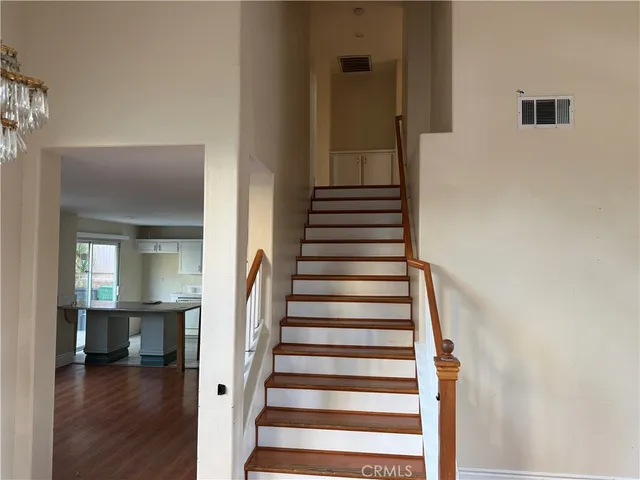 a view of a hallway with wooden floor and entryway