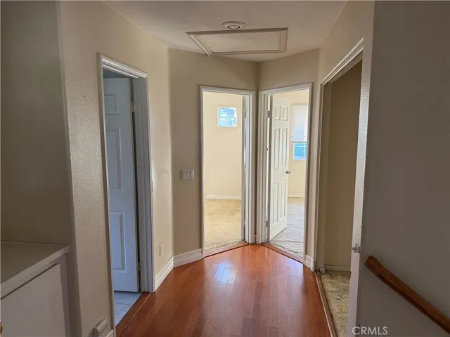 a view of a hallway with wooden floor