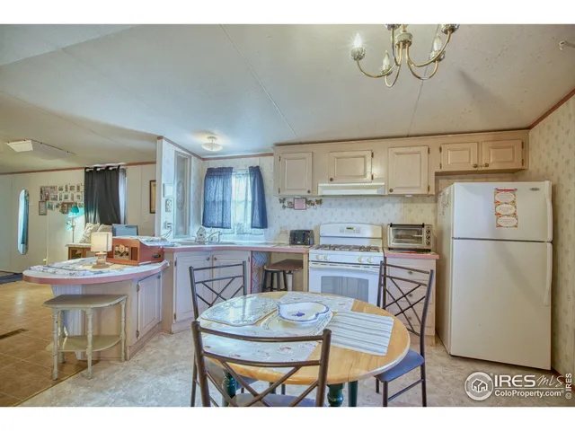 a kitchen with refrigerator cabinets and wooden floor