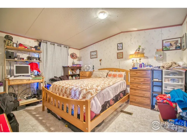 a bedroom with a bed and dresser