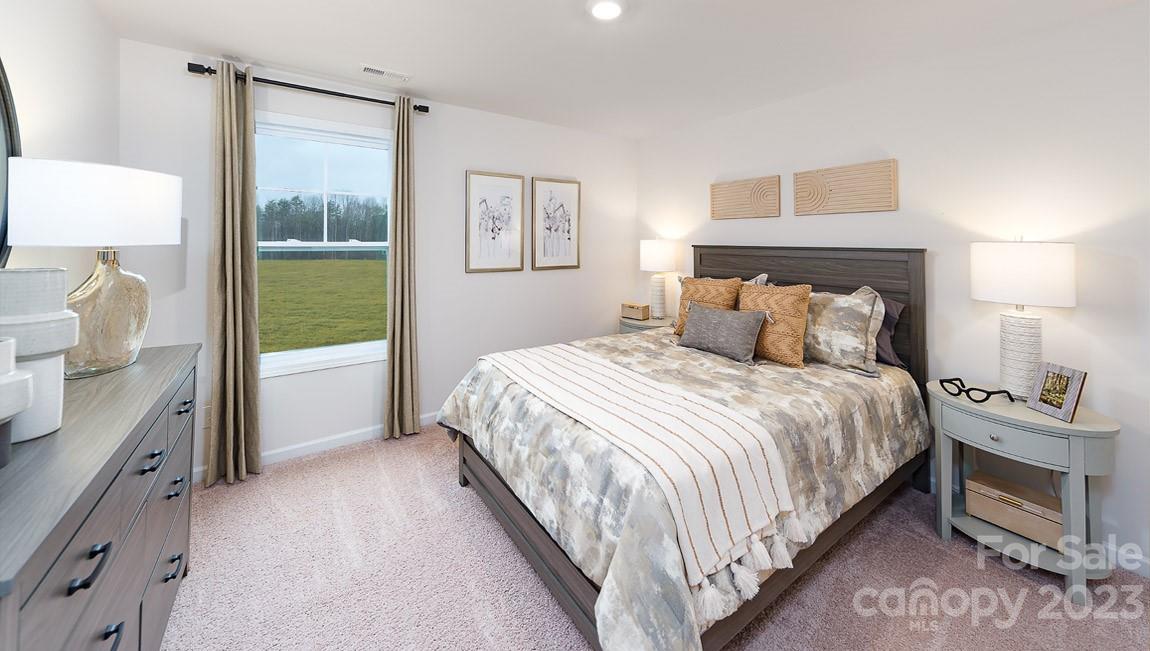 7899 Iron Road Sherrills Ford, NC 28673 - Photo 28 of 41 a bedroom with a bed and a lamp
