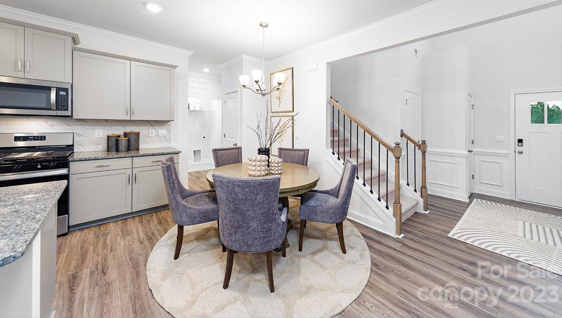7899 Iron Road Sherrills Ford, NC 28673 - Photo 5 of 41 a kitchen with a dining table chairs and white cabinets