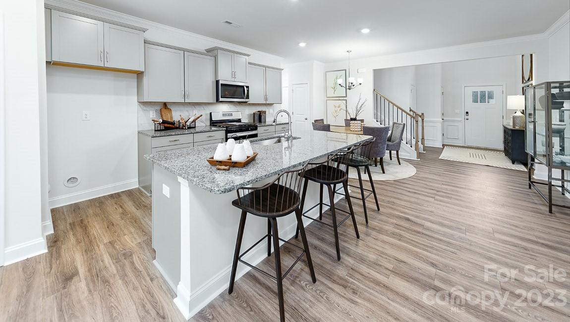7899 Iron Road Sherrills Ford, NC 28673 - Photo 7 of 41 a kitchen with stainless steel appliances a dining table chairs stove refrigerator and cabinets