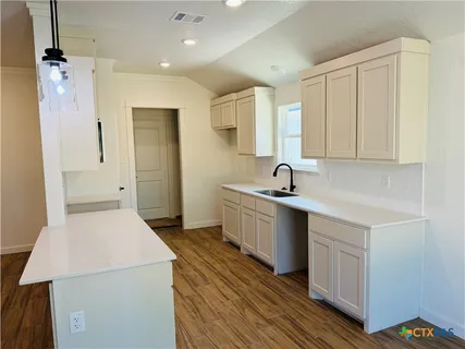 a view of a kitchen with electric appliances