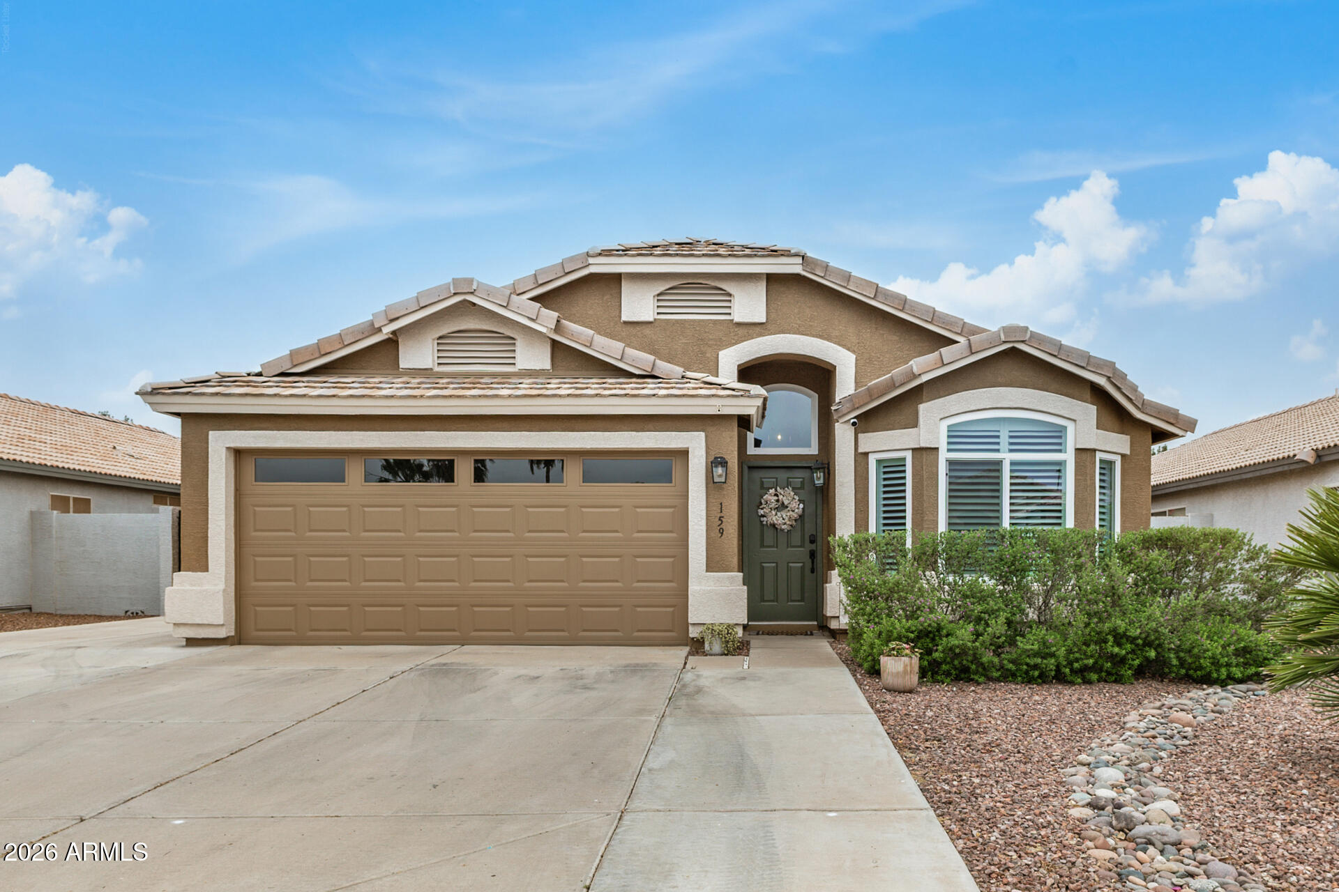 159 West Gail Drive Gilbert, AZ 85233 - Photo 2 of 46 a front view of a house with a yard and garage