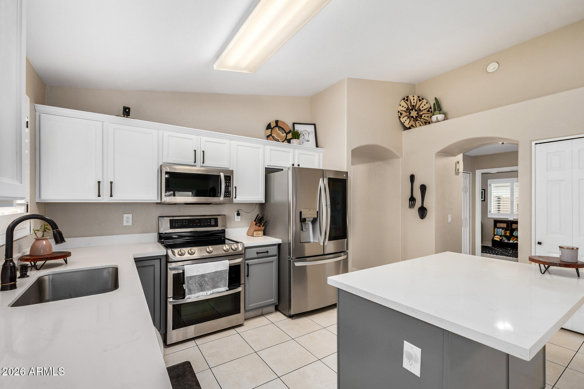 159 West Gail Drive Gilbert, AZ 85233 - Photo 26 of 46 a kitchen with stainless steel appliances a sink stove refrigerator and cabinets