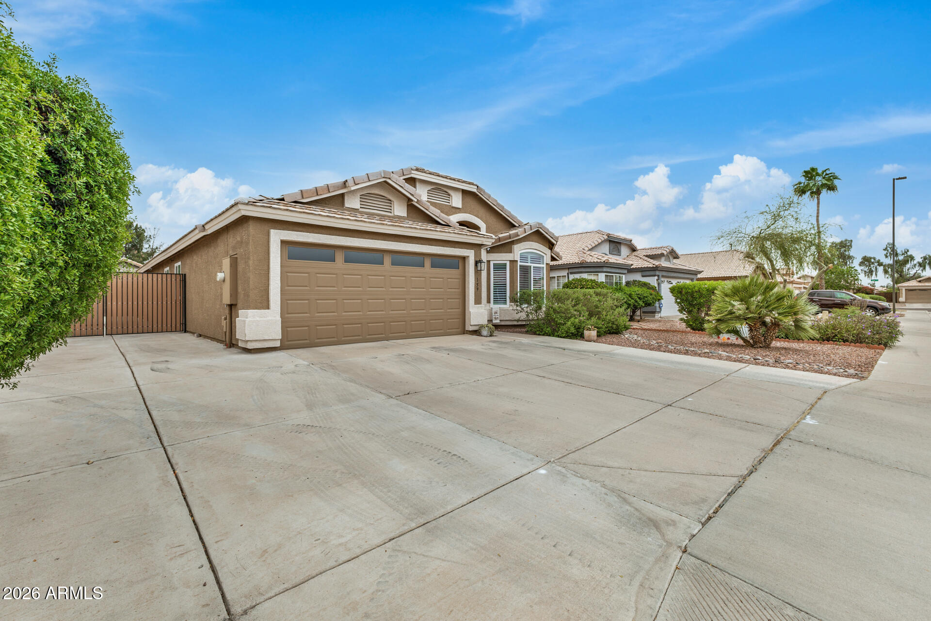 159 West Gail Drive Gilbert, AZ 85233 - Photo 3 of 46 a front view of a house with a yard and garage