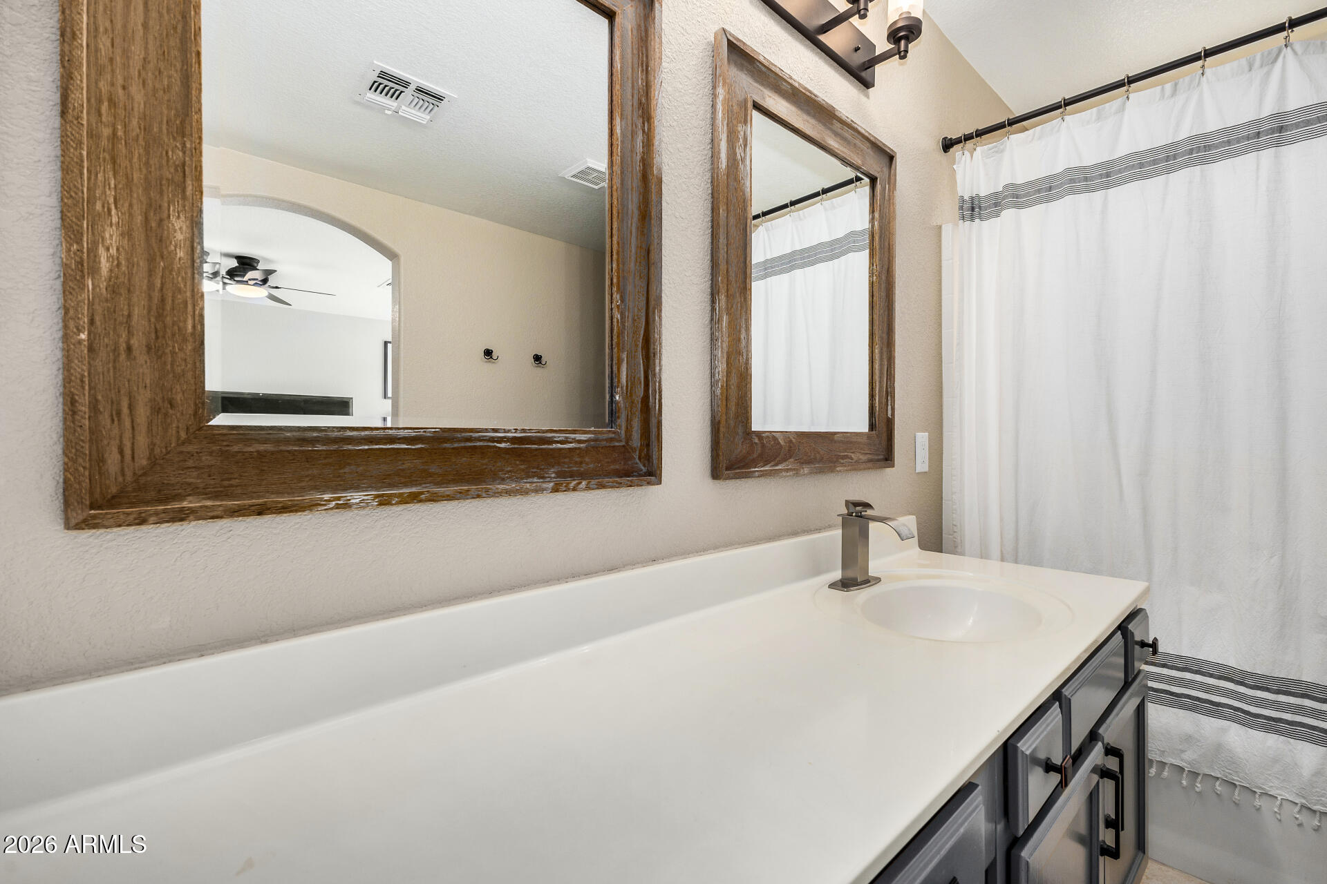 159 West Gail Drive Gilbert, AZ 85233 - Photo 31 of 46 a bathroom with a sink and a mirror