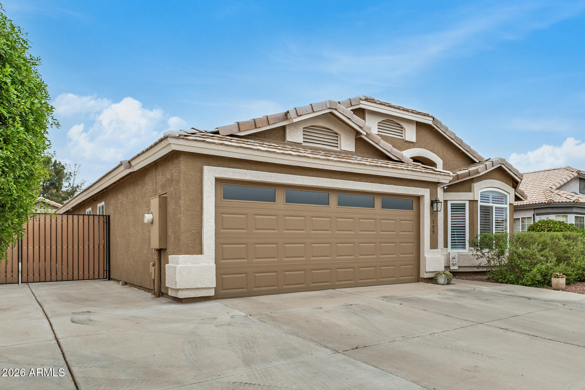 159 West Gail Drive Gilbert, AZ 85233 - Photo 4 of 46 a view of a grey house with garage