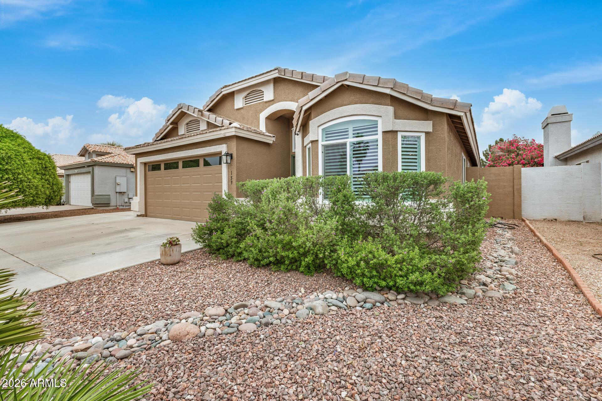 159 West Gail Drive Gilbert, AZ 85233 - Photo 5 of 46 a front view of a house with a garden