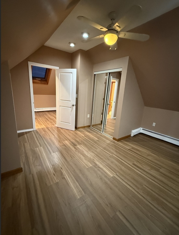 26 Lexington Street, Unit 2 Everett, MA 02149 - Photo 11 of 15 an empty room with wooden floor and windows