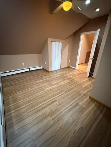 a view of a room with wooden floor