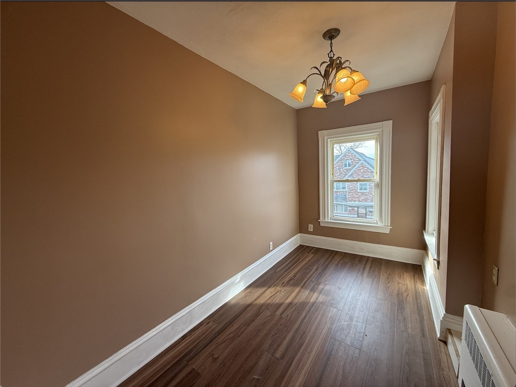 26 Lexington Street, Unit 2 Everett, MA 02149 - Photo 5 of 15 wooden floor in an empty room with a window