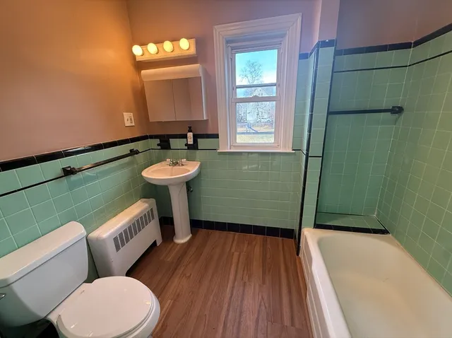 a bathroom with a sink toilet and window