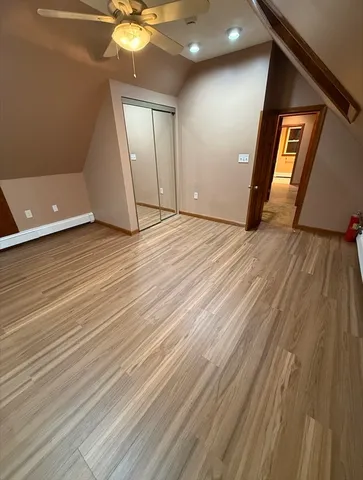 a view of an empty room and wooden floor