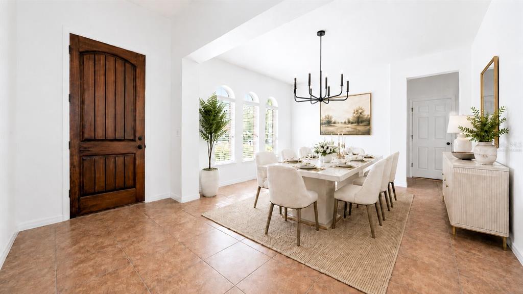 8531 Geddes Loop Orlando, FL 32836 - Photo 2 of 20 a dining room with furniture potted plants and wooden floor